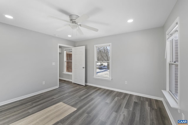 spare room with ceiling fan and dark wood-type flooring