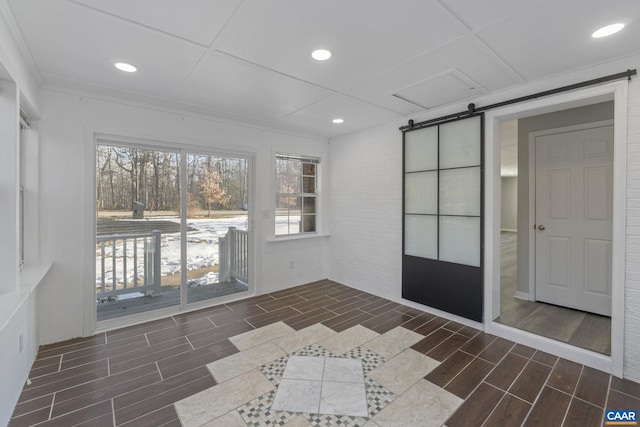 unfurnished sunroom featuring a barn door