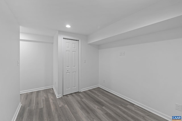 basement with hardwood / wood-style floors