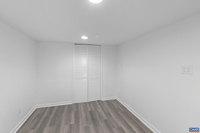 spare room featuring dark wood-type flooring