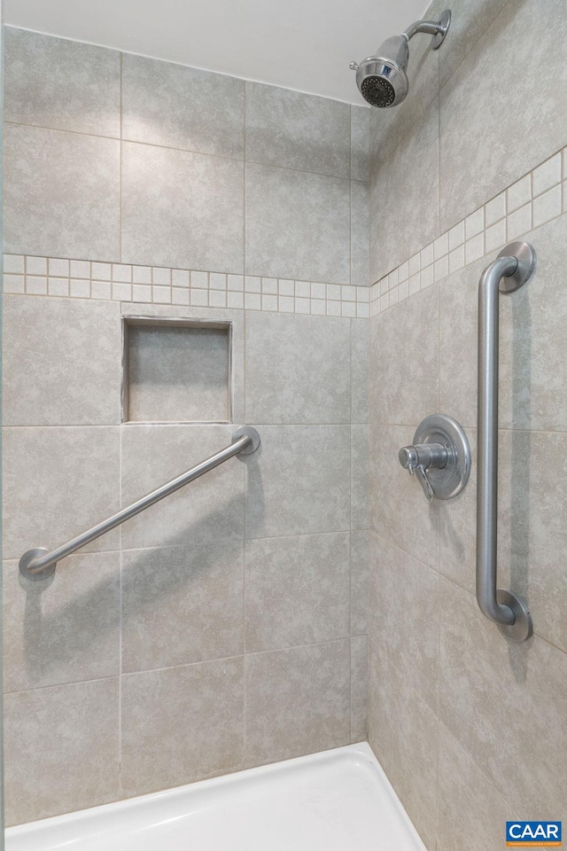 bathroom with tiled shower