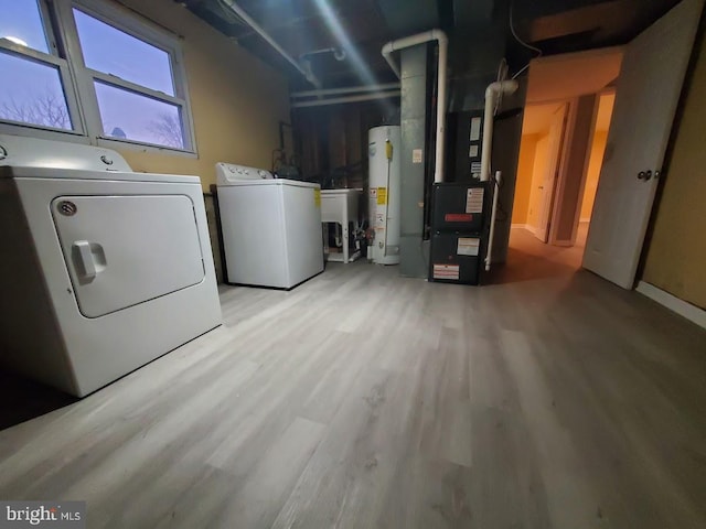 laundry room with light hardwood / wood-style floors, washer and clothes dryer, heating unit, gas water heater, and sink