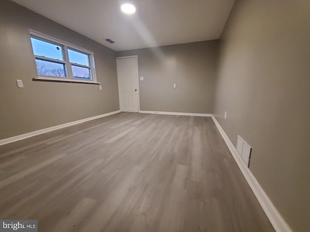 spare room with hardwood / wood-style flooring