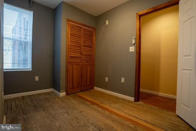 unfurnished bedroom with wood-type flooring