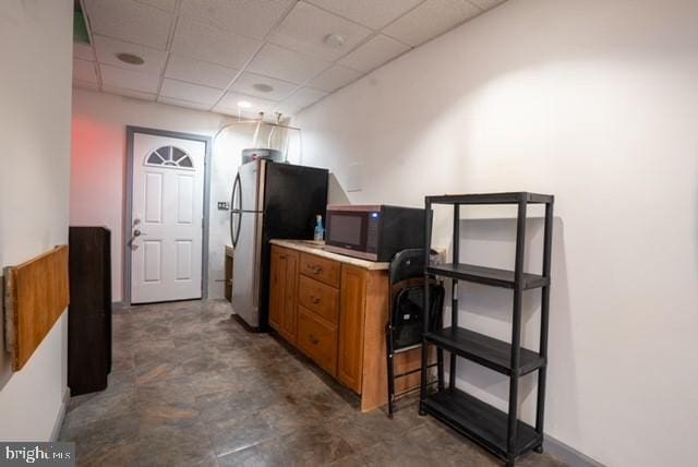 kitchen featuring a paneled ceiling and stainless steel appliances