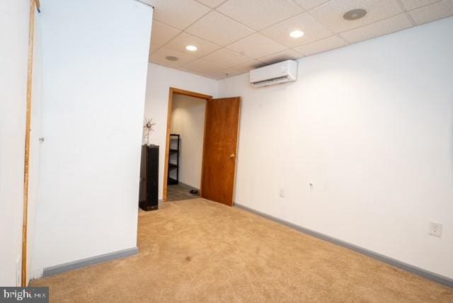 carpeted empty room with a wall unit AC