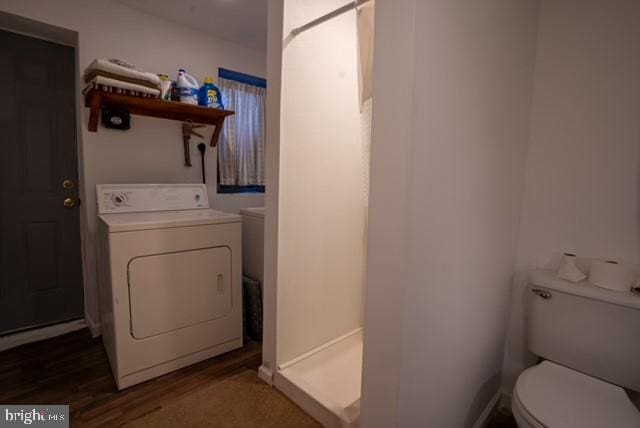 laundry area with dark hardwood / wood-style flooring and washer / clothes dryer