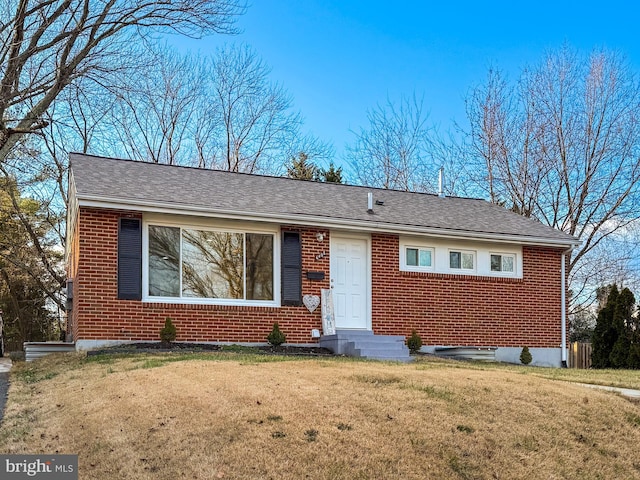 ranch-style home with a front lawn