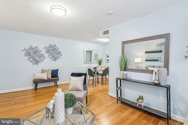 living area with hardwood / wood-style flooring