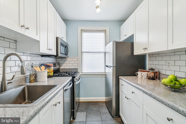 kitchen featuring sink, white cabinets, and stainless steel appliances