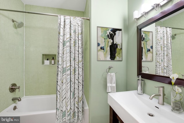 bathroom featuring shower / tub combo with curtain and sink