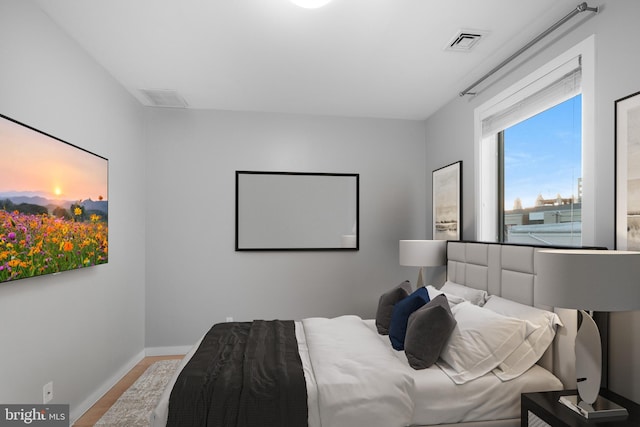 bedroom with hardwood / wood-style flooring