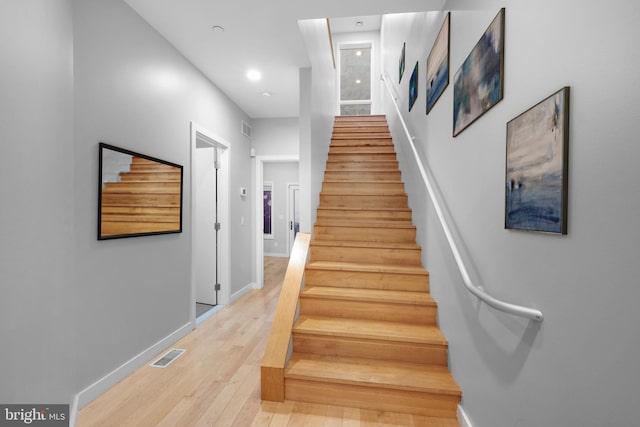 stairway with hardwood / wood-style flooring