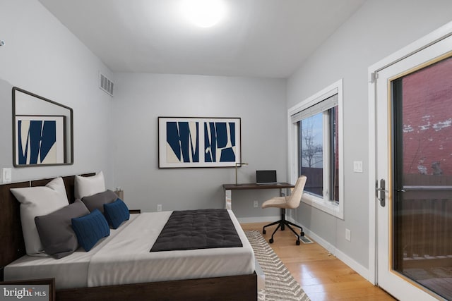 bedroom featuring access to exterior and light hardwood / wood-style floors