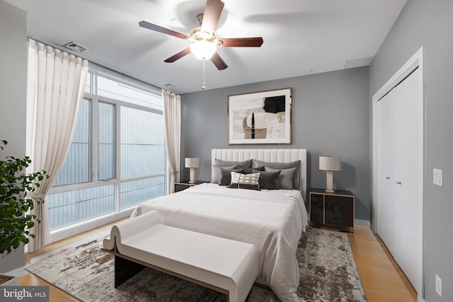 bedroom featuring a closet, ceiling fan, and light hardwood / wood-style flooring