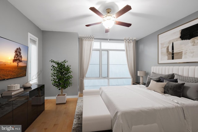 bedroom with hardwood / wood-style flooring and ceiling fan