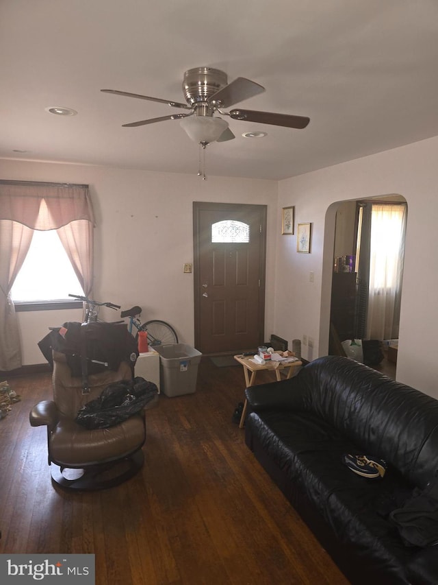 living room with ceiling fan and dark hardwood / wood-style floors