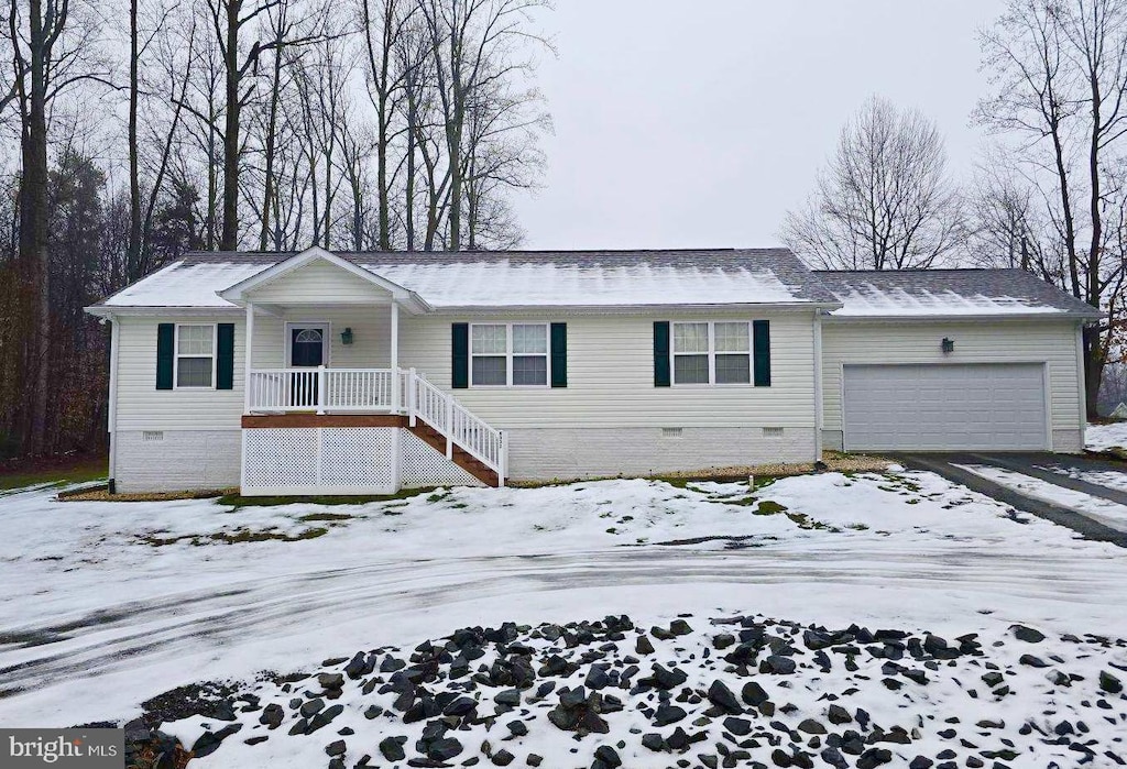 ranch-style home with a garage and a porch