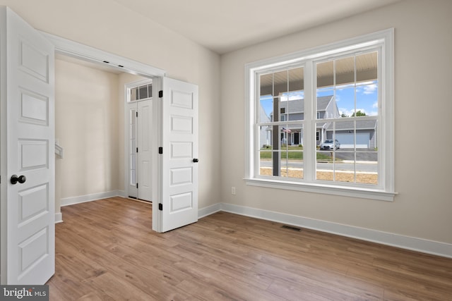 spare room with light wood-type flooring