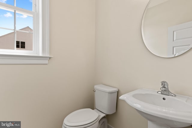 bathroom featuring toilet and sink