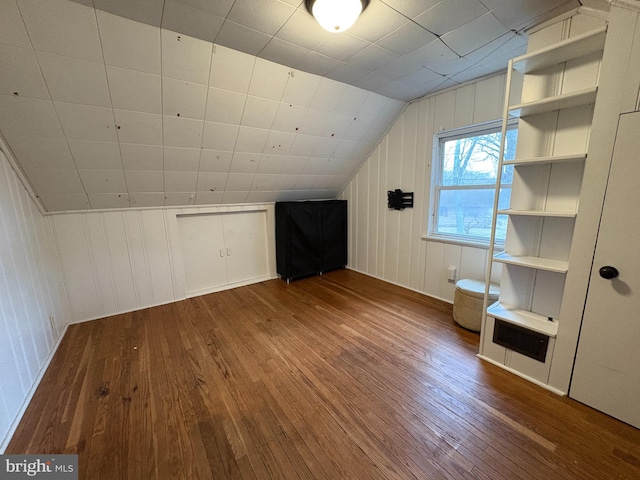 bonus room with wood-type flooring and vaulted ceiling