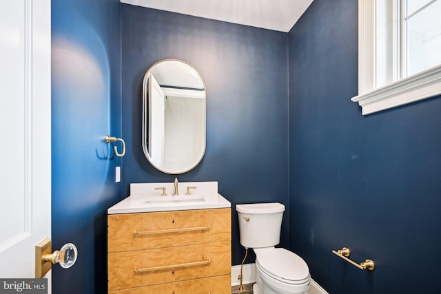 bathroom with toilet and vanity