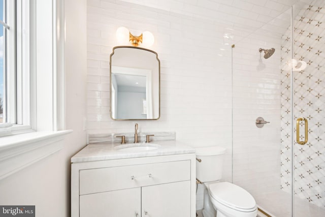 bathroom featuring vanity, toilet, and walk in shower