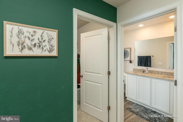 bathroom with vanity and hardwood / wood-style flooring