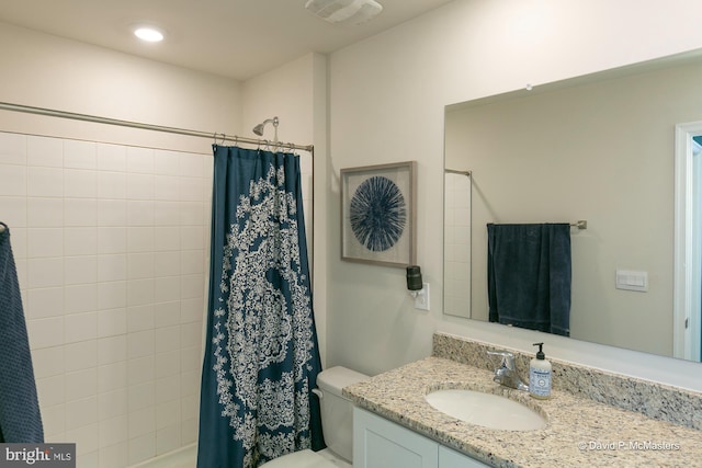 bathroom with vanity, toilet, and walk in shower