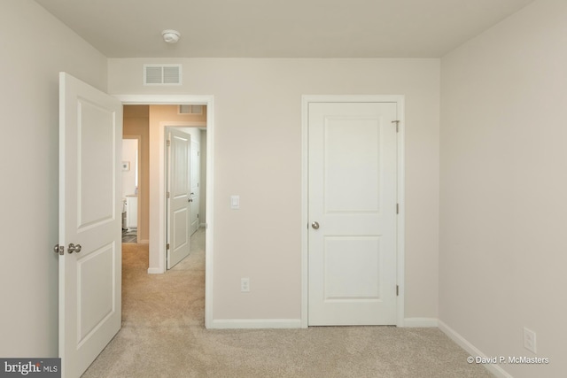 unfurnished bedroom with light colored carpet