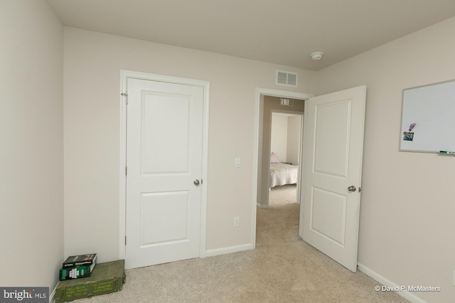 unfurnished bedroom with light colored carpet