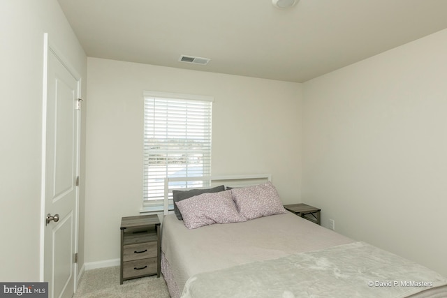 bedroom featuring light carpet