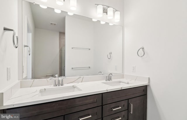 bathroom with vanity, toilet, and walk in shower