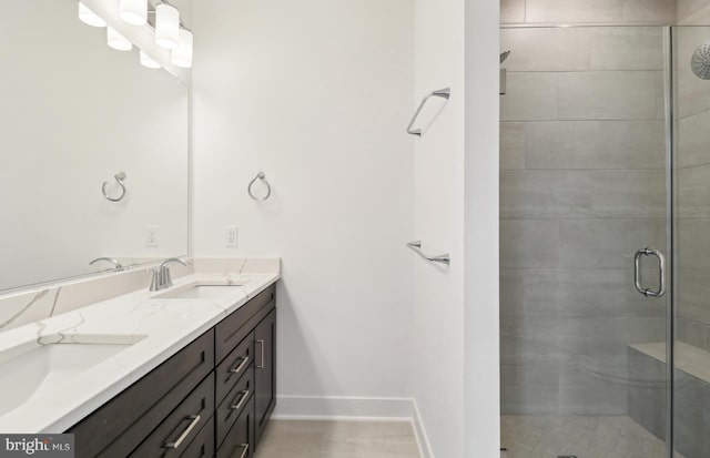 bathroom with vanity and a shower with shower door