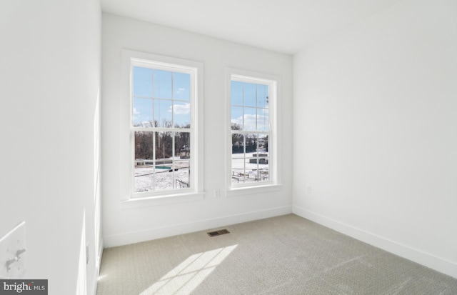 empty room with light colored carpet