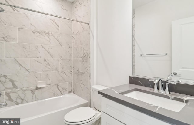 full bathroom featuring tiled shower / bath, vanity, and toilet