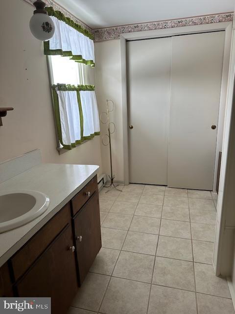 bathroom with tile patterned flooring and vanity