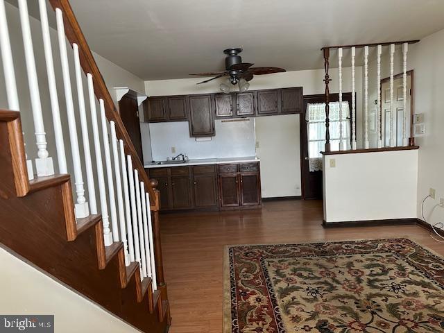 kitchen featuring dark brown cabinetry, dark hardwood / wood-style flooring, and ceiling fan