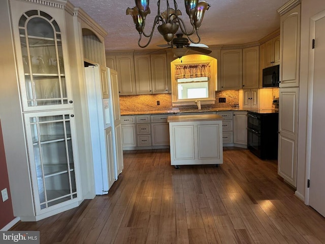 kitchen featuring dark hardwood / wood-style floors, sink, backsplash, and black appliances