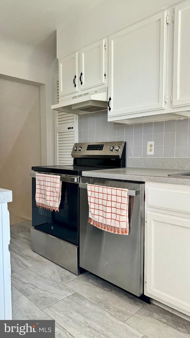 kitchen featuring white cabinets, decorative backsplash, and appliances with stainless steel finishes