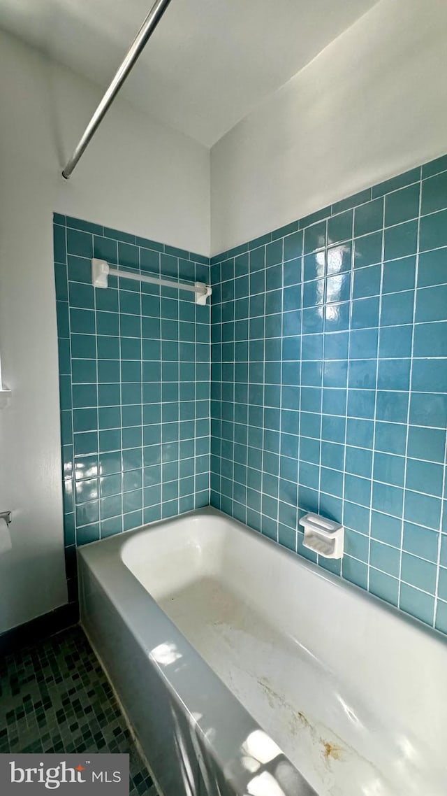 bathroom featuring tile patterned floors and bathtub / shower combination