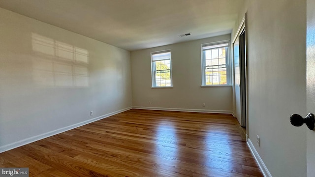 unfurnished room featuring hardwood / wood-style flooring