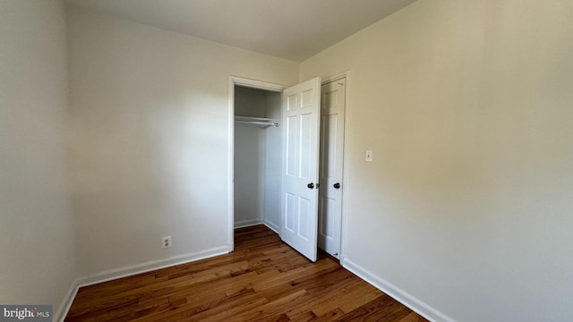 unfurnished bedroom featuring dark hardwood / wood-style flooring