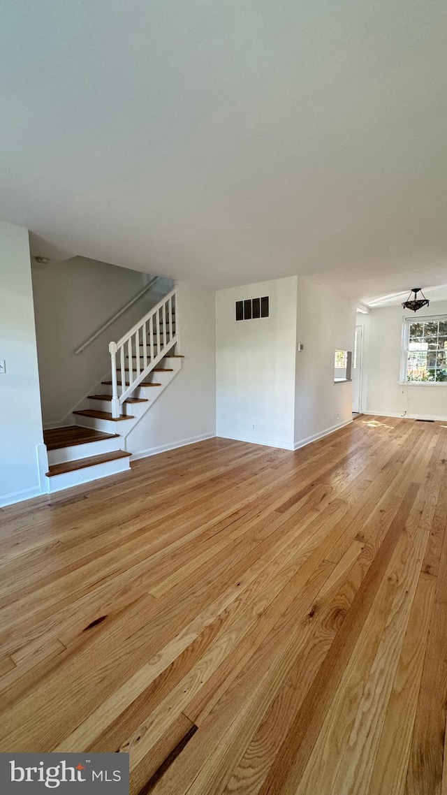 unfurnished living room with light wood-type flooring