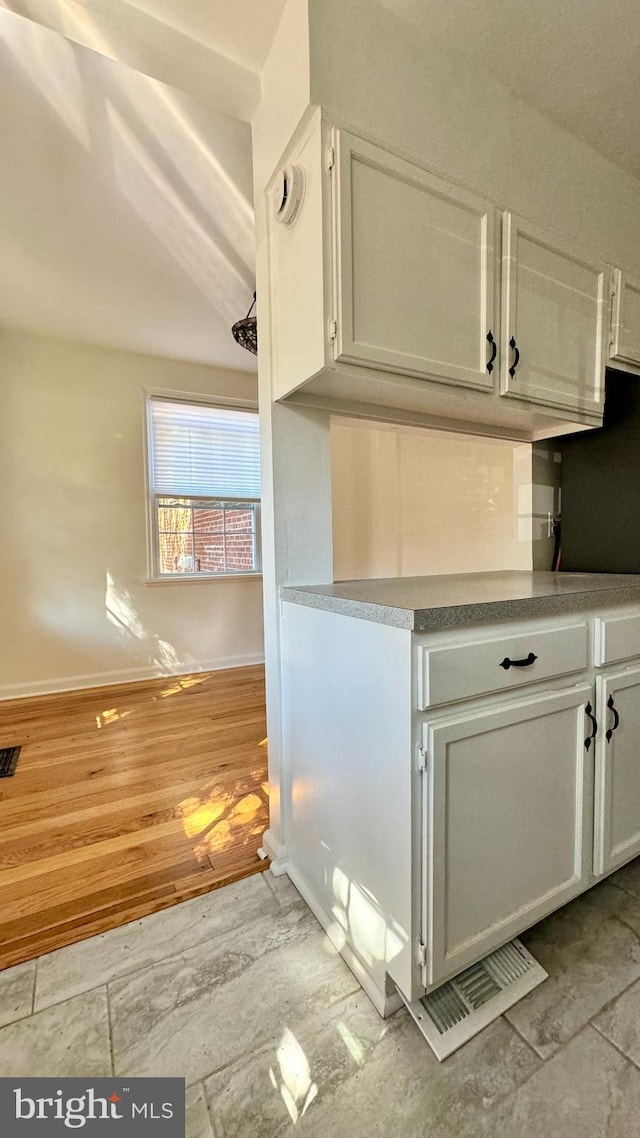 kitchen featuring white cabinetry and light hardwood / wood-style floors