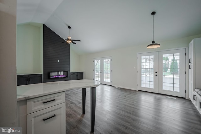 kitchen featuring white cabinets, decorative light fixtures, french doors, ceiling fan, and light stone counters