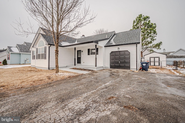 ranch-style house with a garage and a porch