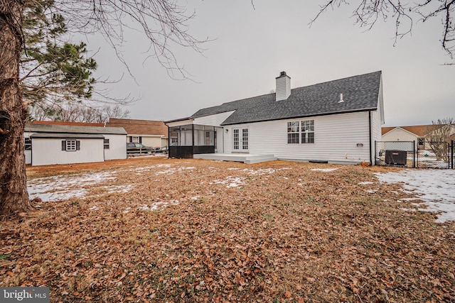 snow covered property featuring a sunroom