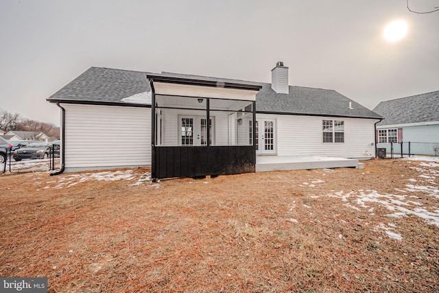 rear view of house featuring french doors