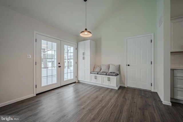 interior space with vaulted ceiling, dark wood-type flooring, and french doors